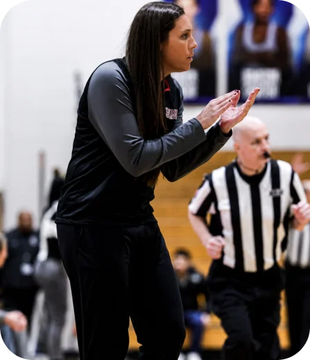 Basketball coach cheering on her team from the sideline